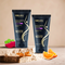 Two Sonama Naturals face wash tubes on a wooden surface, surrounded by fruits and vegetables.