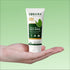 Tube of Sonama Naturals Neem & Tulsi Face Wash held in a hand against a green background