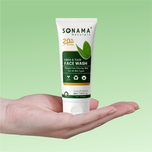 Tube of Sonama Naturals Neem & Tulsi Face Wash held in a hand against a green background